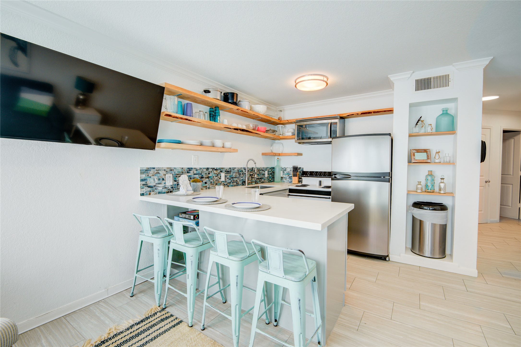 10811 Termini-San Luis Pass Road, Unit 2307 Galveston, TX 77554 - Photo 16 of 32 a kitchen with appliances and cabinets