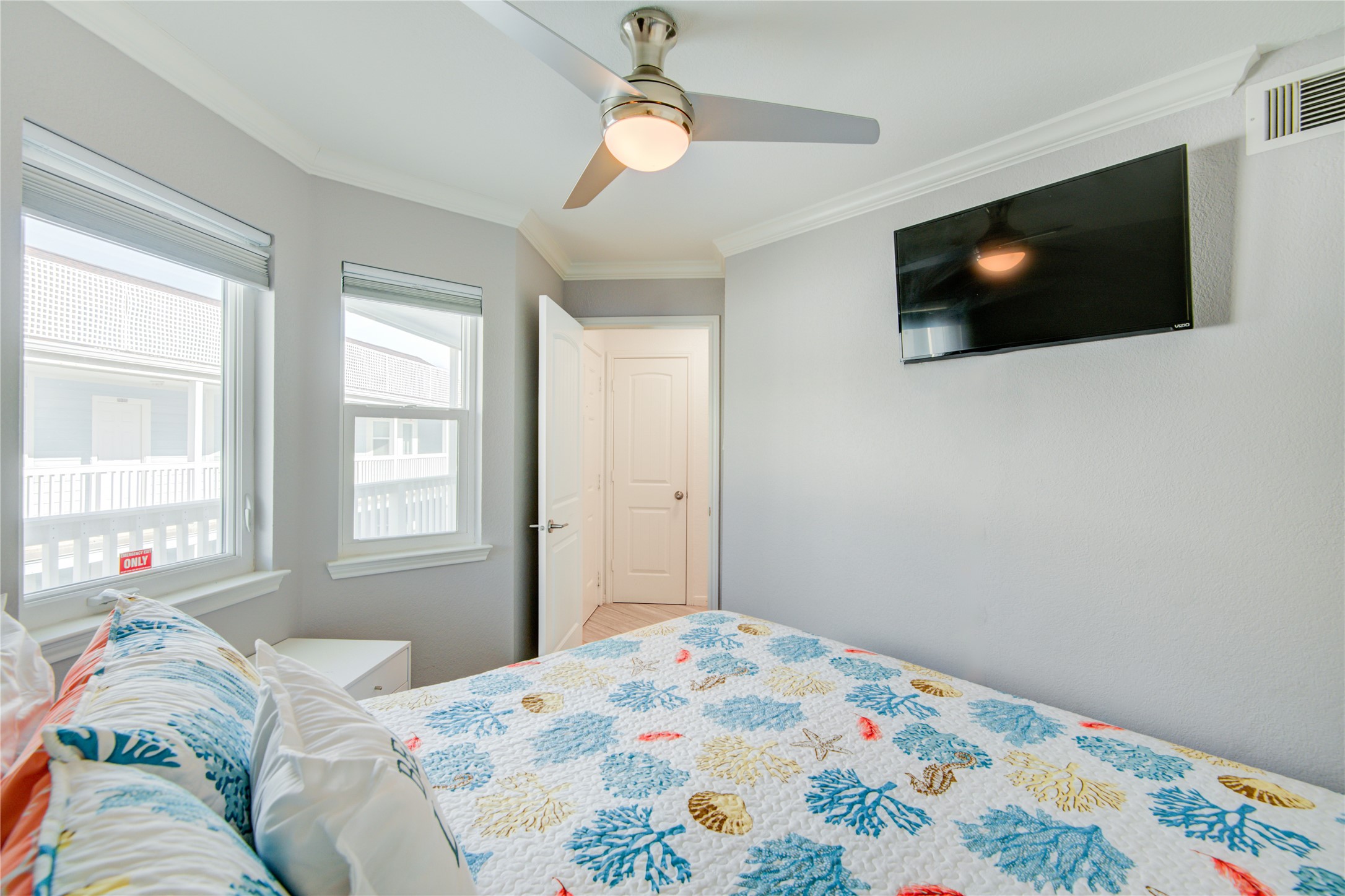 10811 Termini-San Luis Pass Road, Unit 2307 Galveston, TX 77554 - Photo 3 of 32 a bedroom with a flat screen tv and a window