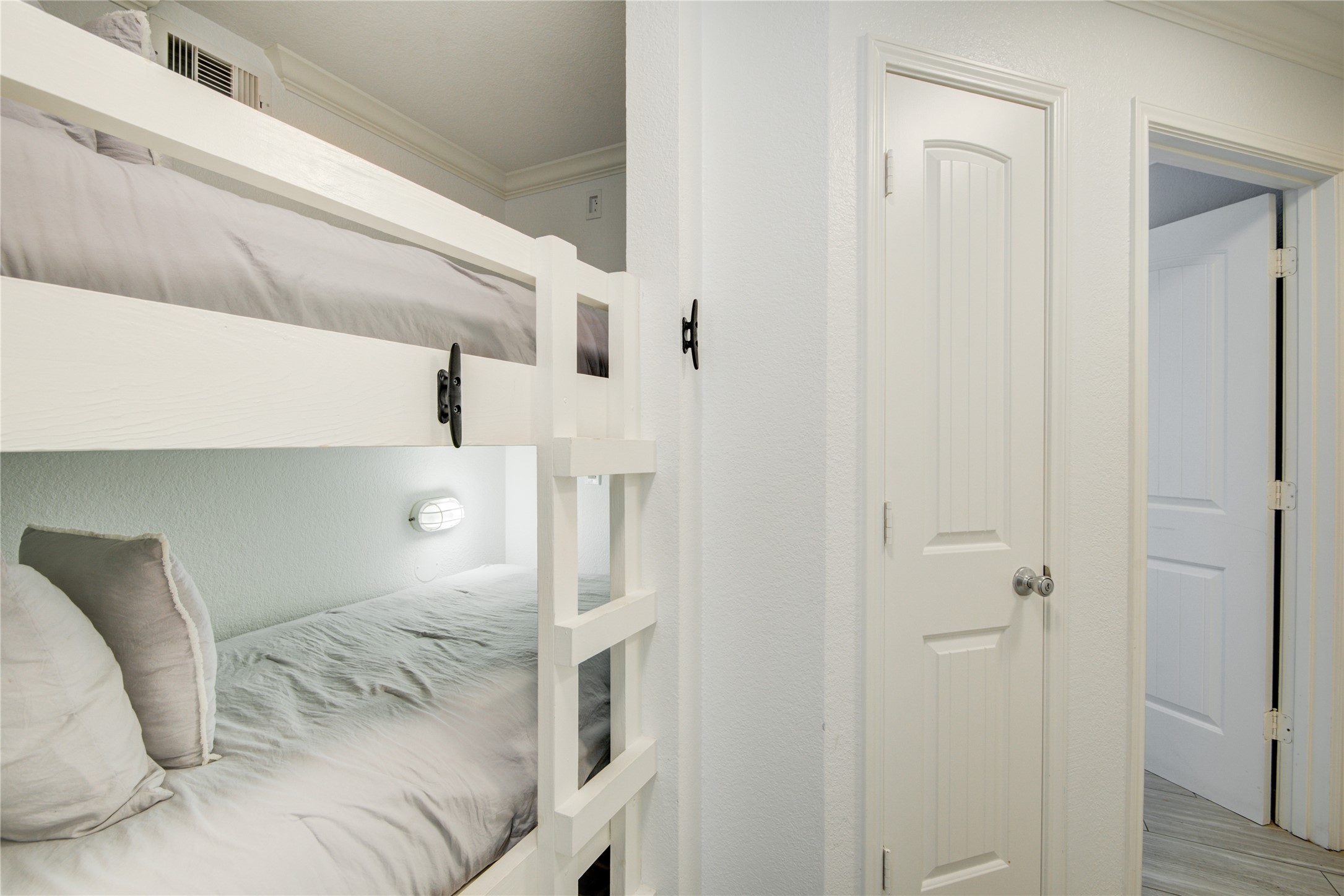 10811 Termini-San Luis Pass Road, Unit 2307 Galveston, TX 77554 - Photo 6 of 32 a bedroom with a bed and a cabinets