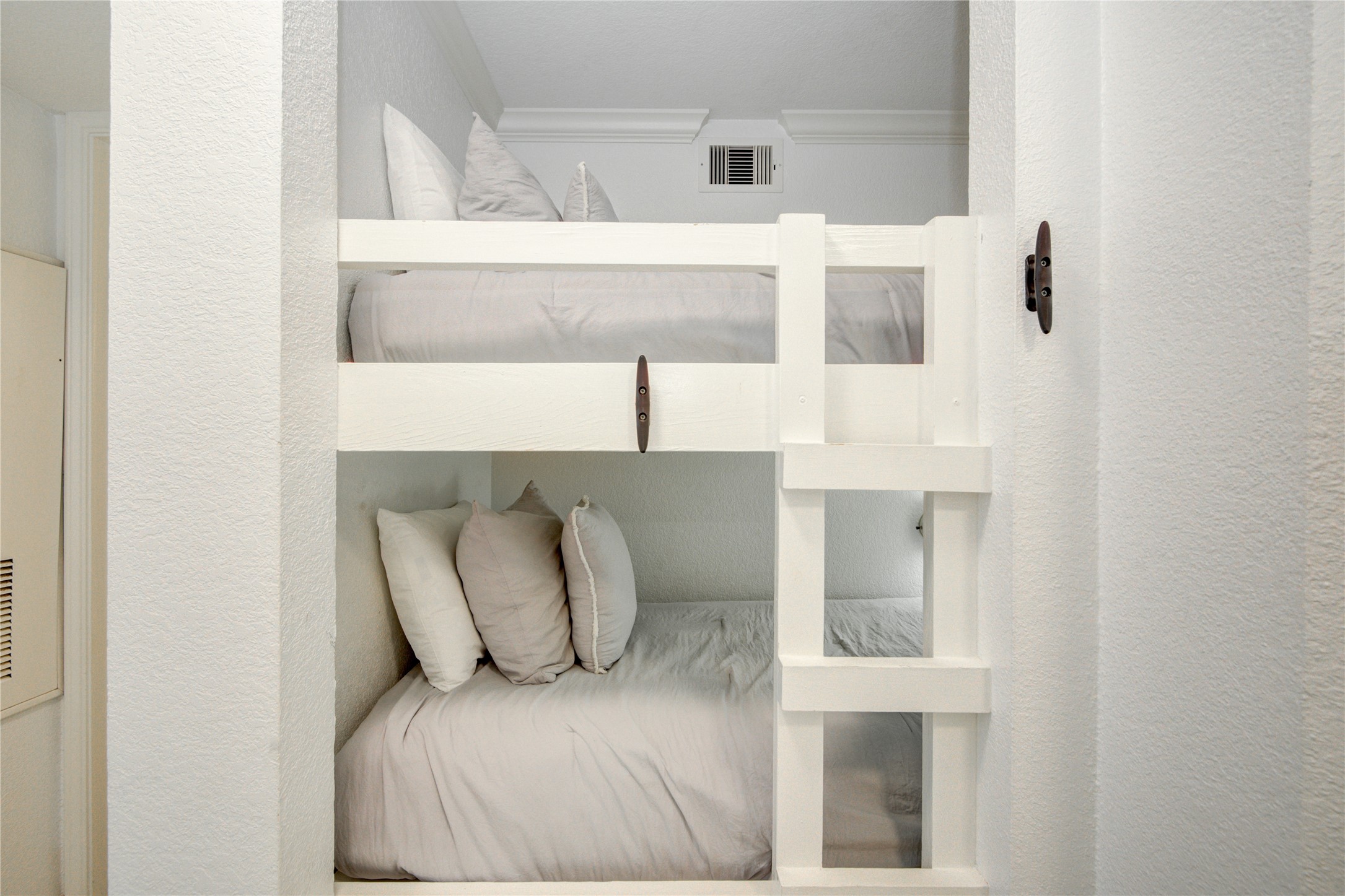 10811 Termini-San Luis Pass Road, Unit 2307 Galveston, TX 77554 - Photo 7 of 32 a white bed sitting in a room next to a white wall