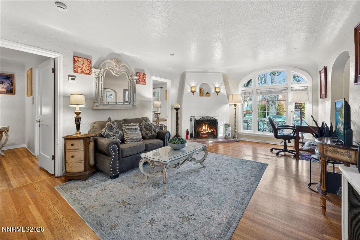 611 Nixon Avenue Reno, NV 89509 - Photo 6 of 43 a living room with furniture large window and a fireplace