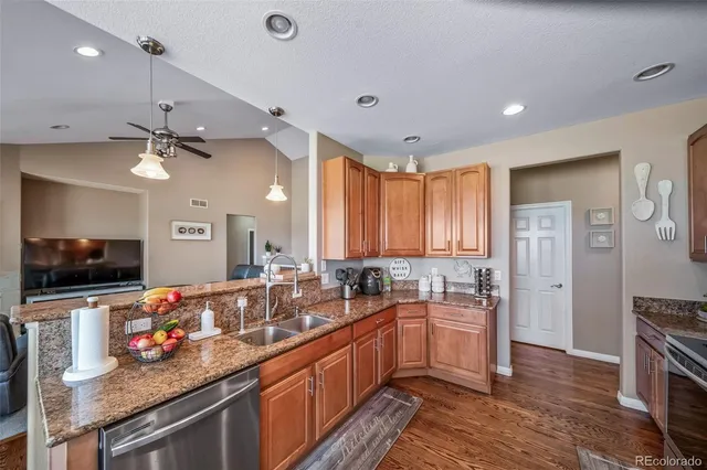 a large kitchen with a large counter top appliances and cabinets