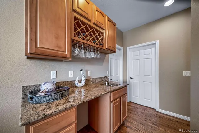 a kitchen with granite countertop stainless steel appliances a sink and cabinets