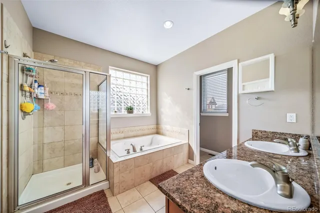 a bathroom with a tub sink and shower