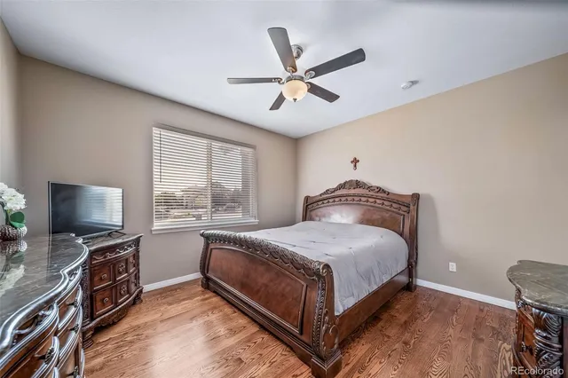 a bedroom with a bed flat screen tv and a window