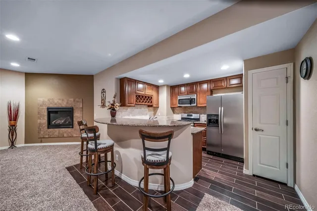 a kitchen with a table chairs refrigerator and microwave