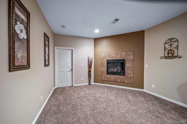 a view of an empty room with a fireplace