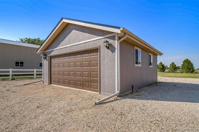 a view of backyard with small cabin