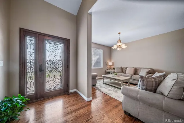 a living room with furniture and a chandelier