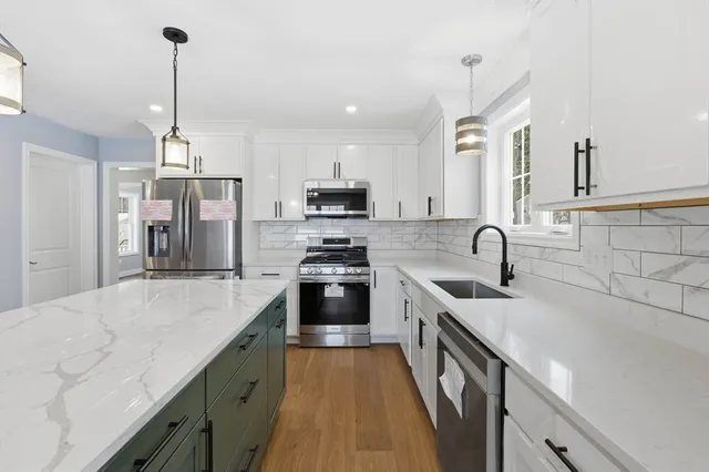 a kitchen with stainless steel appliances granite countertop a sink stove and refrigerator