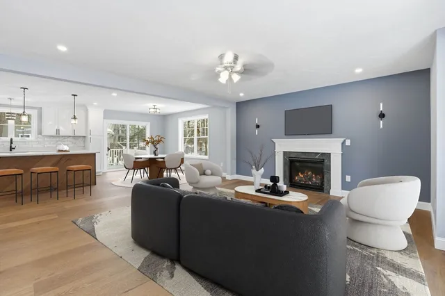 a living room with furniture a fireplace and a flat screen tv