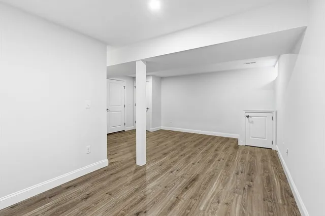 a view of a room with wooden floor