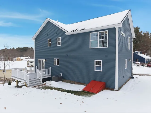 a view of a house with a snow in the background