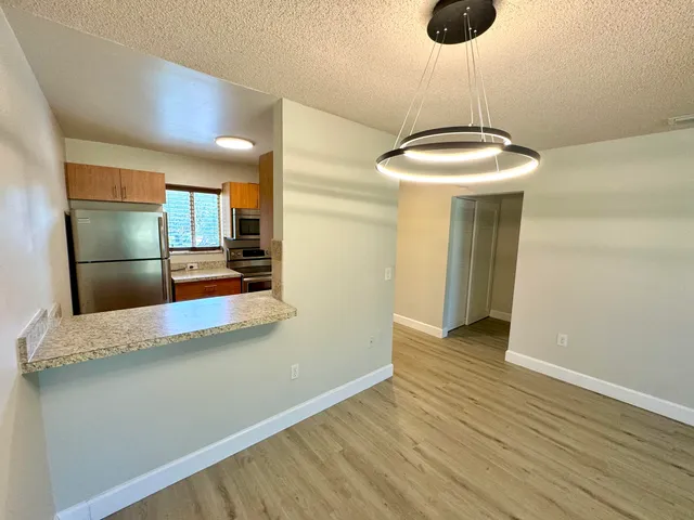 a view of a kitchen with a sink and wooden floor