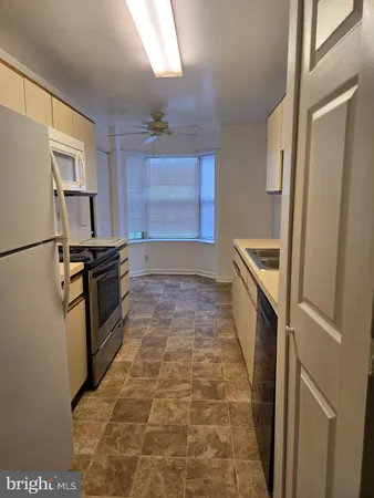 a kitchen with granite countertop a refrigerator and a stove