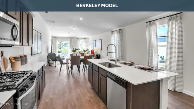 a kitchen with sink stove and cabinets