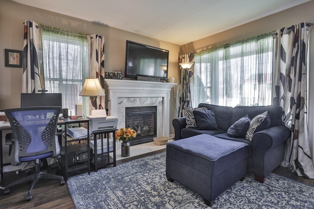 11 Rahway Road Burlington, MA 01803 - Photo 8 of 19 a living room with furniture a flat screen tv and a fireplace