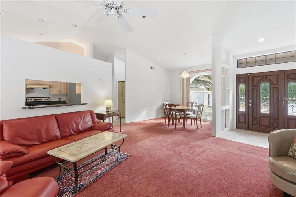 22 Mastic Court West Homosassa, FL 34446 - Photo 11 of 46 a living room with furniture and a dining table with garden view