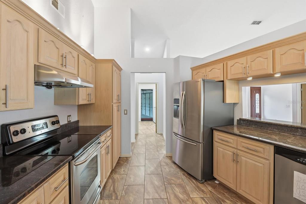 22 Mastic Court West Homosassa, FL 34446 - Photo 14 of 46 a kitchen with stainless steel appliances granite countertop a refrigerator a stove and a sink with cabinets