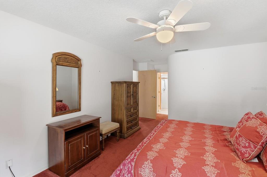 22 Mastic Court West Homosassa, FL 34446 - Photo 21 of 46 a bedroom with a bed and a chandelier