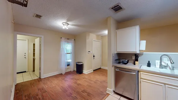 a kitchen with a refrigerator and a sink