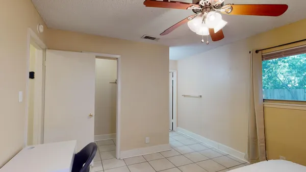 a view of room with window and ceiling fan