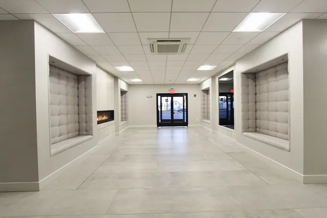 a view of an empty room with a fireplace