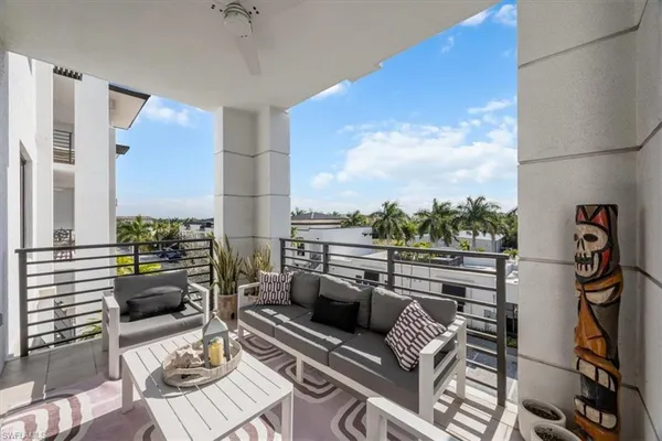 a balcony with furniture and a rug