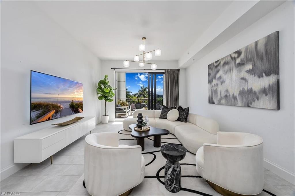 1111 Central Avenue, Unit 401 Naples, FL 34102 - Photo 10 of 36 a living room with furniture and a chandelier