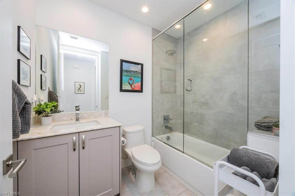 1111 Central Avenue, Unit 401 Naples, FL 34102 - Photo 13 of 36 a bathroom with a sink a toilet and shower