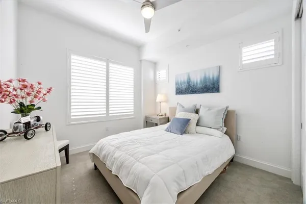 a bedroom with a bed and a lamp