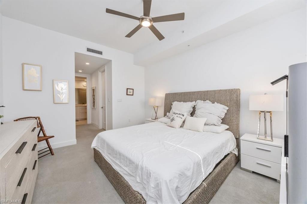 1111 Central Avenue, Unit 401 Naples, FL 34102 - Photo 15 of 36 a bedroom with a bed and ceiling fan