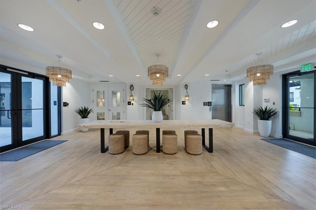 1111 Central Avenue, Unit 401 Naples, FL 34102 - Photo 28 of 36 a large white kitchen with lots of counter space and furniture