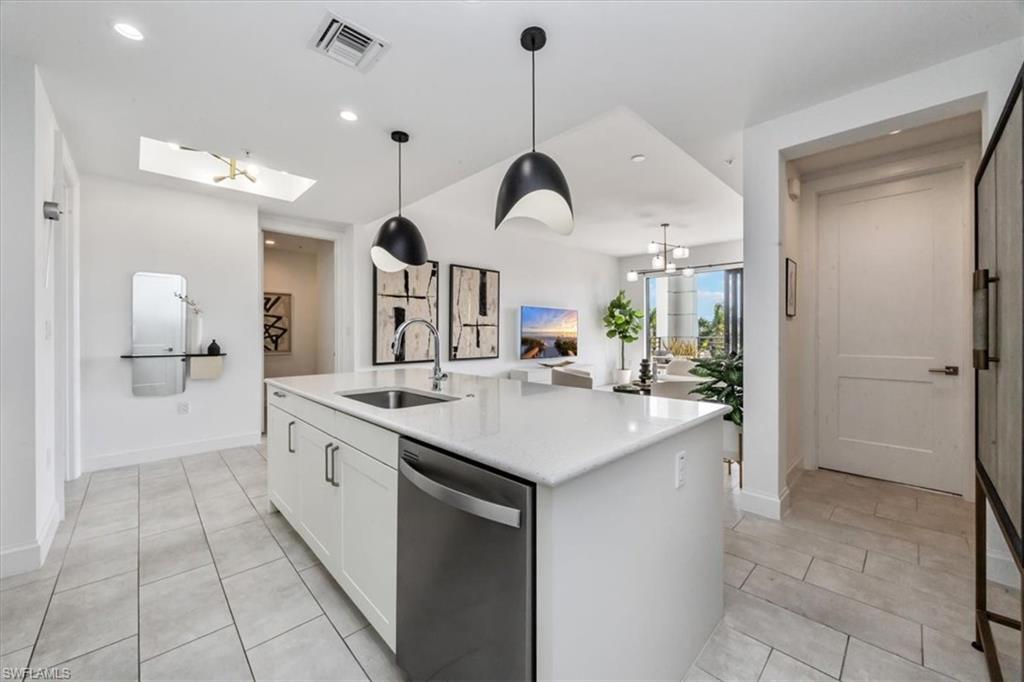 1111 Central Avenue, Unit 401 Naples, FL 34102 - Photo 36 of 36 a kitchen with a sink and a refrigerator