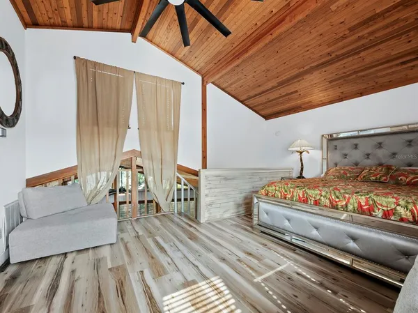 a bedroom with furniture and wooden floor