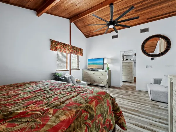 a bed room with a bed and a television