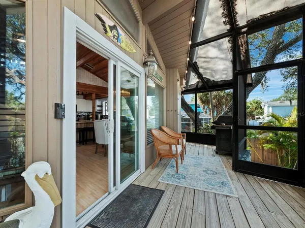 a balcony with chairs and wooden floor