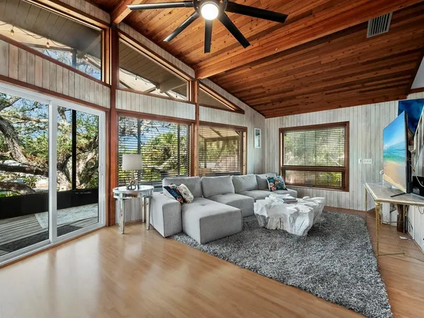a living room with furniture and large windows