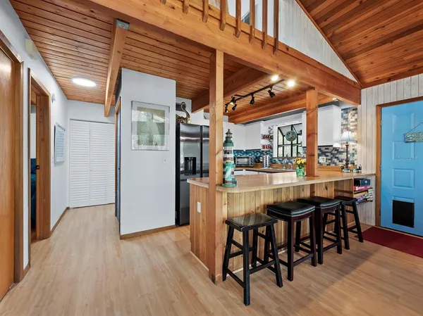a dining room with furniture and wooden floor