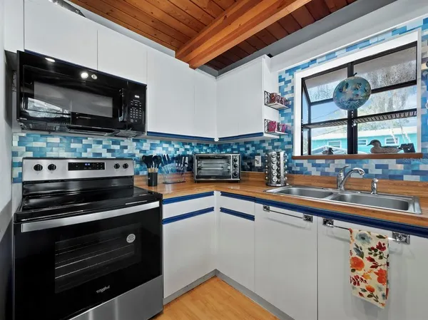 a kitchen with stainless steel appliances a stove and a microwave