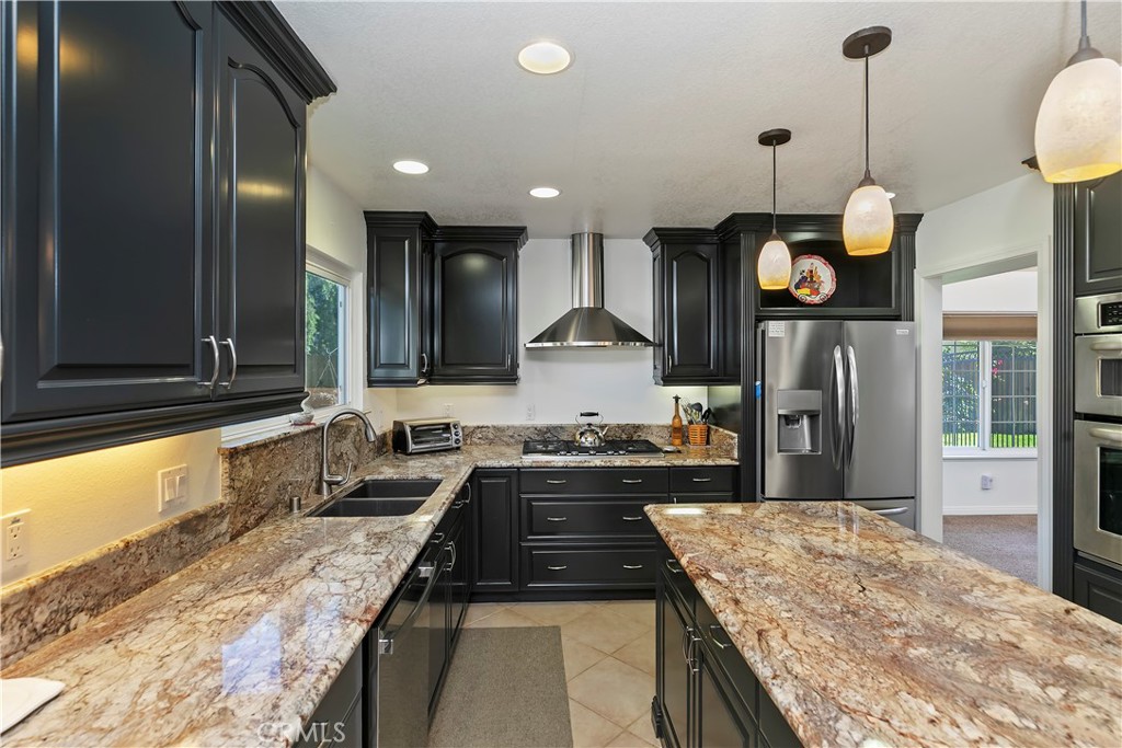 276 Cottonwood Avenue Riverside, CA 92506 - Photo 14 of 69 a kitchen with stainless steel appliances granite countertop sink stove and refrigerator
