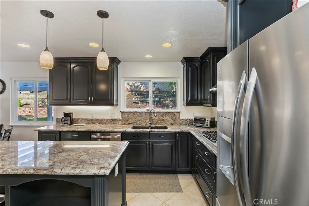 276 Cottonwood Avenue Riverside, CA 92506 - Photo 15 of 69 a kitchen with stainless steel appliances granite countertop a sink stove a refrigerator and a oven with wooden floor