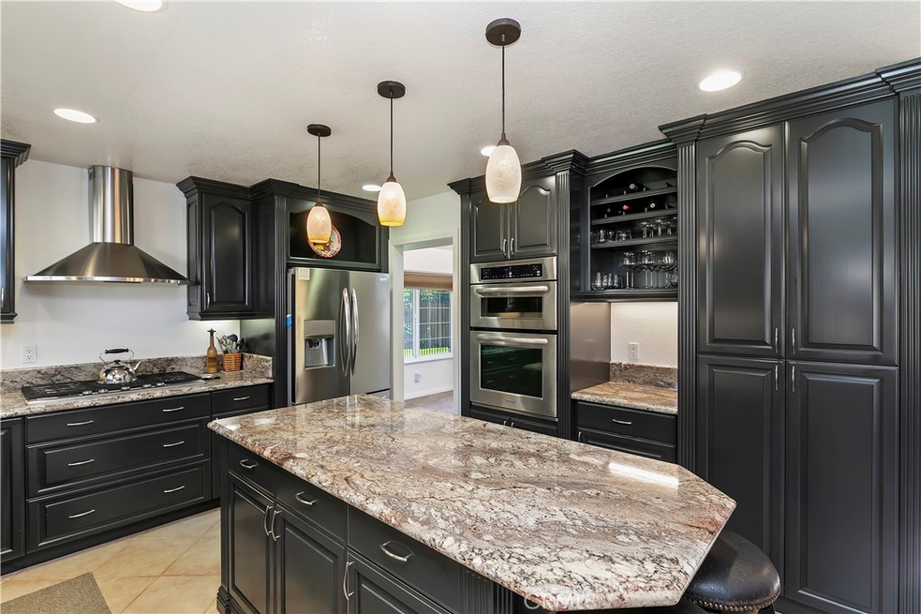 276 Cottonwood Avenue Riverside, CA 92506 - Photo 16 of 69 a kitchen with stainless steel appliances granite countertop a refrigerator a stove and a sink