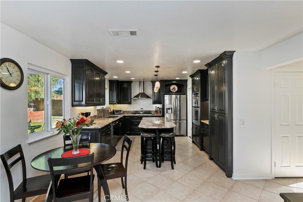 276 Cottonwood Avenue Riverside, CA 92506 - Photo 18 of 69 a kitchen with a table and chairs in it
