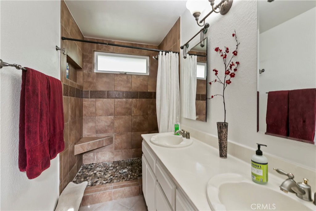 276 Cottonwood Avenue Riverside, CA 92506 - Photo 30 of 69 a bathroom with a sink vanity granite and a shower