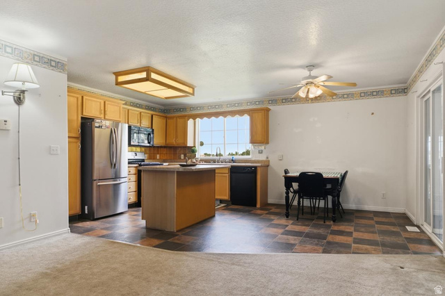 435 East 4th North Preston, ID 83263 - Photo 5 of 26 Kitchen featuring wood cabinetry, stainless steel refrigerator, built-in microwave, and a central island