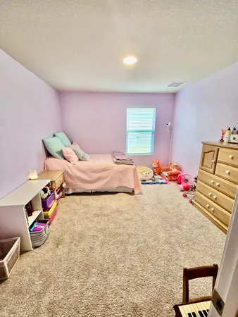 a bedroom with bed and gym equipment