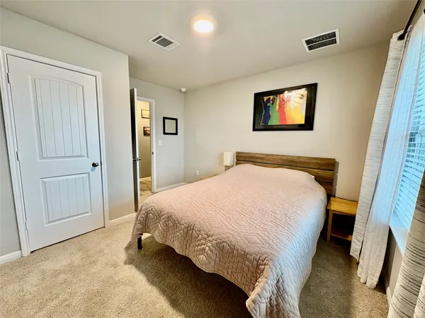 a bedroom with a bed and a dresser