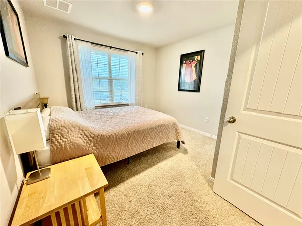 a bedroom with a bed and a mirror