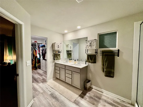 a kitchen with kitchen island a sink appliances and cabinets